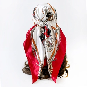 Detail showing classic horse carriage print on silk-like square scarf tied as a headscarf