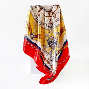 Detail of baroque silk scarf featuring classic golden chains and vintage patterns