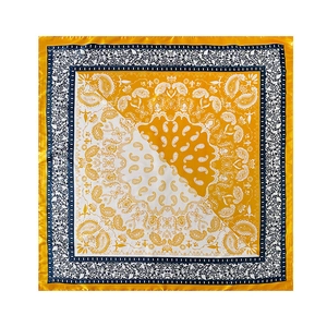 Detailed texture of 90cm yellow paisley silk square scarf with classic print pattern