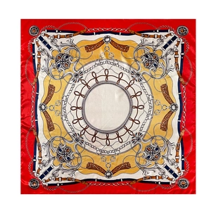 Detail of red and yellow silk scarf featuring classic golden chain and belt prints