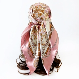 Detailed view of pink satin square scarf featuring classic baroque chain and belt prints