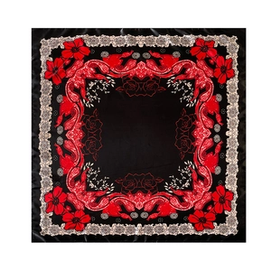 Detail of satin floral scarf featuring red roses and paisley pattern on black base