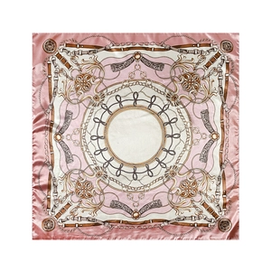 Detail of pink silk square scarf featuring classic golden chain and baroque buckle print