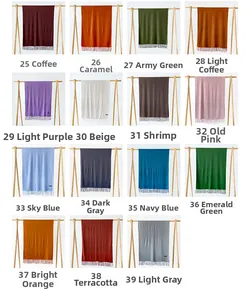 Macro shot showing fifteen color variations of solid cashmere-like scarves with tassel fringe