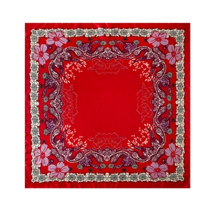 Flat lay of red satin square scarf with paisley floral prints and lace border details