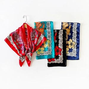 Detailed view of four premium satin silk square scarves with classic paisley print patterns