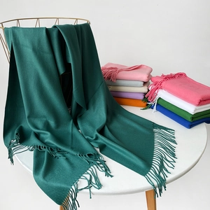 Detail of dark green pashmina scarf with long fringes and a variety of color options