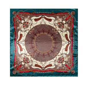 Detailed macro view of high-quality silk satin square scarf with vintage chain and belt print