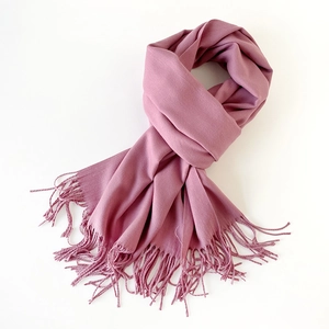 Detailed view of the soft rose pink shawl scarf featuring neat handmade tassel edges