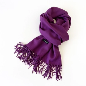Detail shot of purple cashmere scarf featuring soft texture and elegant fringe edges
