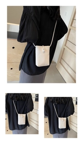 Detail of cream white leather mini phone bag with an elegant pearl button closure