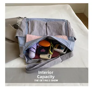 Interior view of large capacity crossbody bag showing storage for umbrella and books