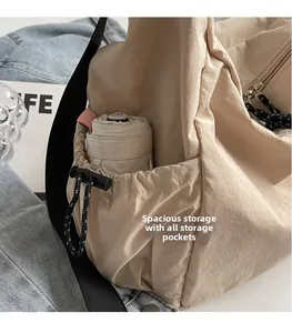 Detail of canvas tote bag side pocket holding an umbrella with drawstring closure