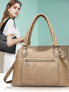 Women's washed leather tote bag with dual handles and adjustable shoulder strap in beige