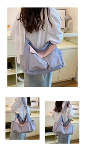 Detail view of pink and purple canvas bag showing side pockets and adjustable strap