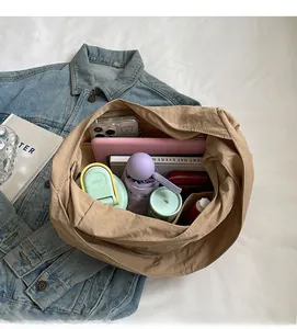 Large capacity khaki tote bag showing spacious interior with iPad, umbrella and notebook