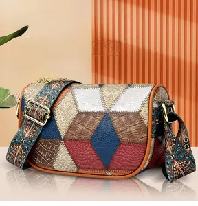 Detailed view of geometric patchwork shoulder bag with colorful ethnic style wide strap