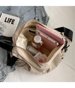 Macro view showing large capacity and internal space of this beige canvas crossbody bag