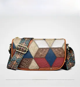 Front view of geometric patchwork shoulder bag with colorful textures and wide strap