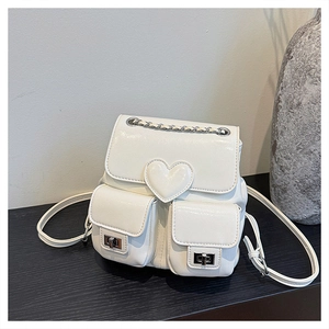 Detail of white PU leather backpack with heart quilting and silver metal twist locks