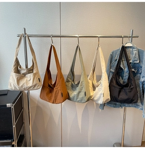 Minimalist large-capacity canvas shoulder bags displayed in five various colors