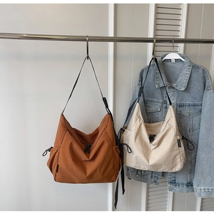Detail of adjustable nylon straps and drawstring design on the large canvas tote bags