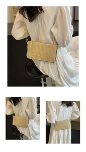 Detail of woven straw shoulder bag with silver bead trim and metallic chain strap
