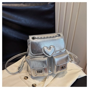 Detail of silver metallic mini backpack with heart stitching and chain handle