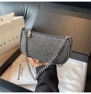 Detail of grey denim bag featuring silver rhinestones and a metal chain strap