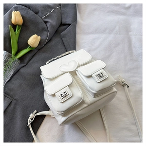 Close-up of a white PU leather backpack featuring heart decor and silver turn-lock pockets