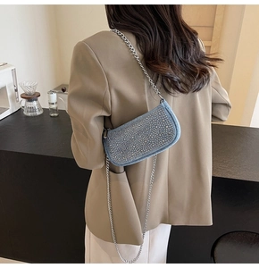 Chic blue denim underarm bag with silver rhinestone studs and a metallic chain strap