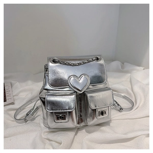 Detailed shot of silver metallic mini backpack with heart design and chain handle