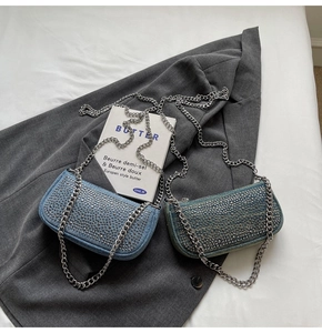 Close-up of vintage denim handbags with sparkling rhinestones and silver chain straps
