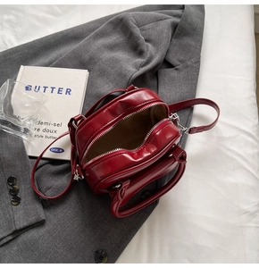 Detailed interior view of a red leather bridal bag with silver hardware and lining
