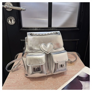Detail of silver metallic mini backpack with heart stitching and chain handle