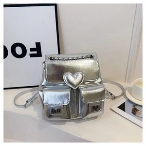 Silver metallic mini backpack with embossed heart and dual pockets with silver twist locks