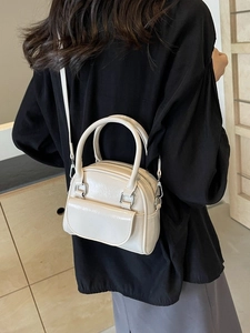Elegant cream white glossy leather mini handbag shown with modern outfit lifestyle view