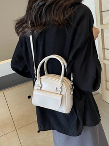 Elegant beige glossy faux leather handbag with top handles and silver metal hardware