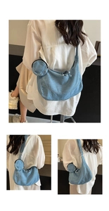 Detail of light blue denim crescent bag featuring a matching round coin purse on strap
