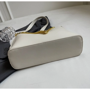 Detail view of the wide base and fine leather texture of the ivory chain tote bag