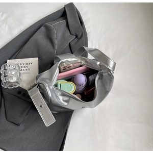 Detailed top view of a large silver metallic tote bag showing spacious storage capacity