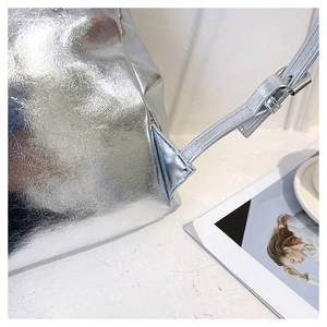 Detailed close-up of metallic silver backpack straps and high-quality stitch craftsmanship
