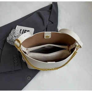 Top view of large white tote bag interior with zipper compartment and chain detail