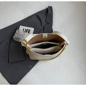 Top view of white leather tote bag interior with zip pocket and brown lining