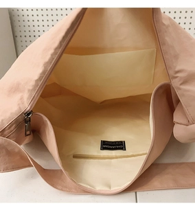 Detail of spacious nylon tote interior with functional zip pocket and inner compartments