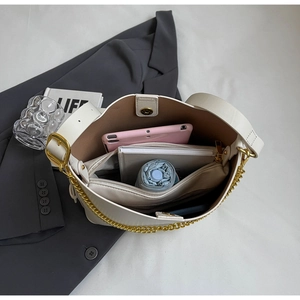 Overhead view showing large capacity interior of white tote bag with tablet and umbrella