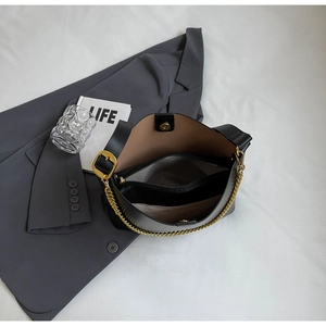 Top view of spacious tote bag interior with compartments and gold chain details