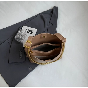 Detailed top view of the spacious multi-layer interior of a camel leather tote bag