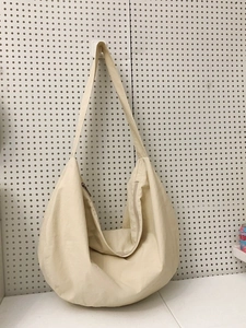 Minimalist beige nylon crescent tote bag with large capacity and adjustable shoulder strap