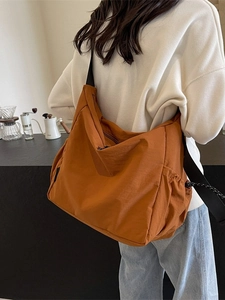 Brown-orange large capacity canvas messenger bag with adjustable black strap and side pocket